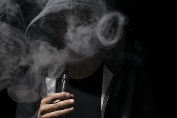 Young person doing circles with vaping cloud.