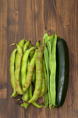 green fresh vegetables on brown wooden background