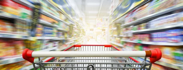 Foto op Plexiglas Supermarket aisle with empty red shopping cart © nonnie192