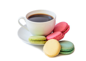 White coffee cup with colorful macaroons isolated on white background