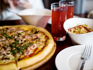 Pizza and glasses with juice on the table. Business lunch