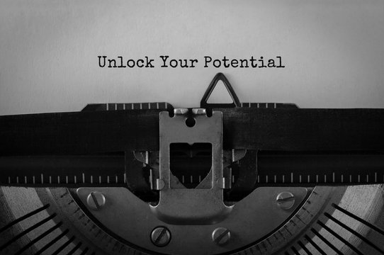 Text Unlock Your Potential typed on retro typewriter