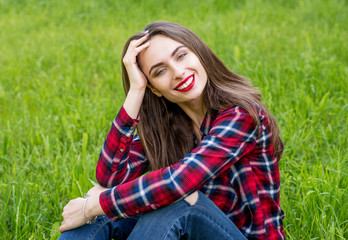 Beautiful Young Woman Outdoors. Enjoy Nature. Healthy Smiling Girl in Green Grass.