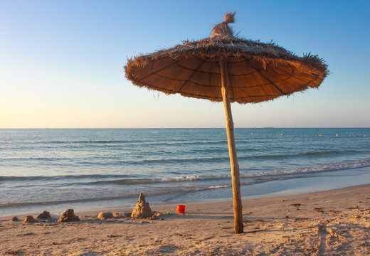 Straw Umbrella On The Beach