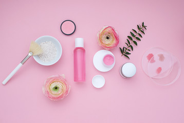 Natural cosmetic pink flat lay with flowers. Top view.
