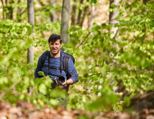 Male tourist with backpack in the forest