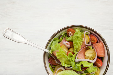 Lettuce salad with salmon and vegetables 
