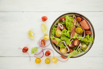 Lettuce salad with salmon and vegetables 
