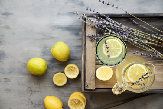 Lemonade with lemons and lavender on gray  shabby table
