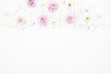 Pink flowers, purple petals on white background. Wedding dress. Flat lay, top view. Feminine  background