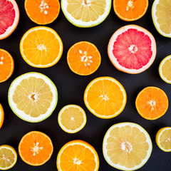 Fototapeta na wymiar Citrus fruits vegan vitamin mix isolated on dark background. Flat lay, top view. Tropical summer mix grapefruit, orange, mandarin, lime