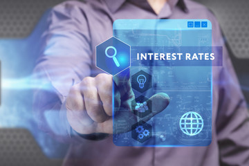Business, Technology, Internet and network concept. Young businessman working on a virtual screen of the future and sees the inscription: Interest rates
