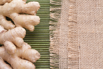 Powdered roots and ginger grated on wooden background