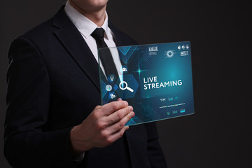 Business, Technology, Internet and network concept. Young businessman working on a virtual screen of the future and sees the inscription: Live streaming