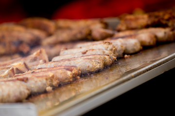 Cooking pork sausages in a street market