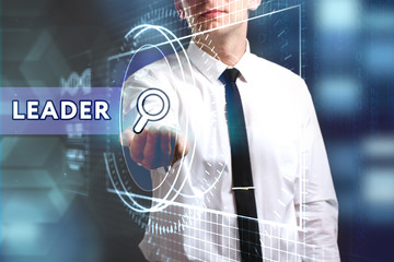 Business, Technology, Internet and network concept. Young businessman working on a virtual screen of the future and sees the inscription: Leader