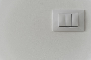 White light switch on a white wall - 144748087
