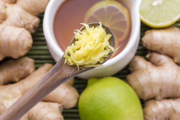 Powdered roots and ginger grated on wooden background