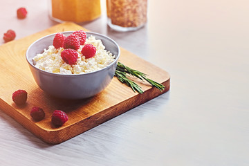 Diet curd with raspberry in a cup.