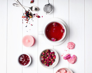 Herbal rose tea, dry roses and other pink colored objects