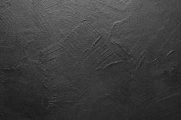 Uneven surface of plastered wall - black background or texture