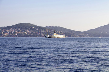 View of traditional public ferry with Prince islands in the background in Istanbul.