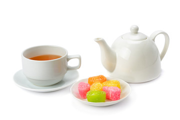 Teapot, tea in a cup and jujube isolated on white background.