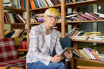 Beautiful woman with glasses reading a text