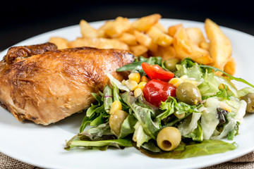 Chicken skewers with sauce and golden French fries potatoes