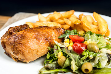 Chicken skewers with sauce and golden French fries potatoes