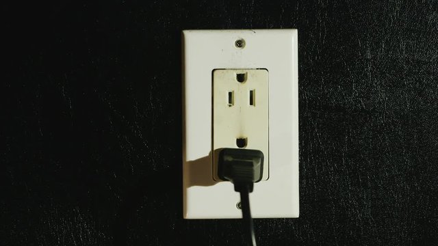 Timelapse: Fire in a dual-socket US type. Streams of black smoke come from the outlet. Danger to life and health