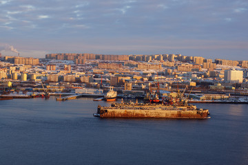 Panorama of the sea city at sunset, the old ship dock stands on the pier in the middle of the bay