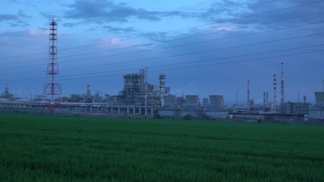 oil factory panoramic side video on sunset