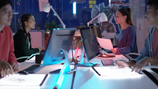  Young Asian video game developers working together on a project