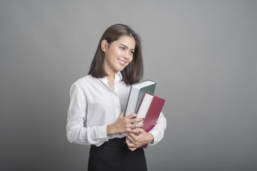 Beautiful teacher Woman holding book on grey background
