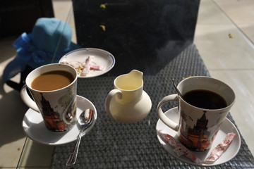 Two cup of coffee one with milk and one without