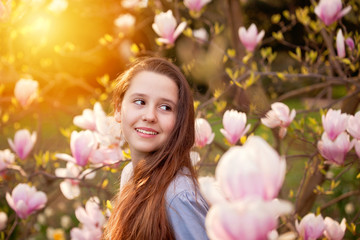 Obraz na płótnie Canvas Young teenager girl in the spring magnolia garden