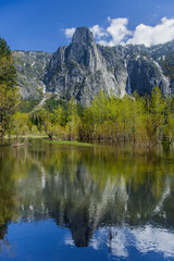 Fototapeta na wymiar Mountain and trees reflected in lake