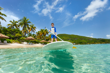 Little boy on stand up paddle board
