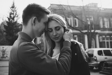 Young couple have fun in sunny day. Beautiful brunette girl and guy outdoor. The concept of tenderness and affection