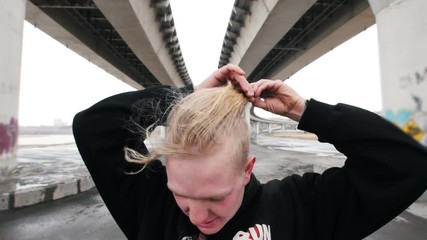 Work-out under bridge - albino man removed hood before training - fitness concept