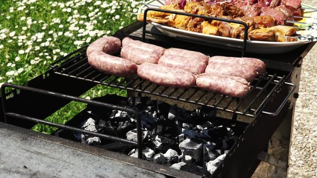 Sausages, chicken and beef getting cooked for summer barbecue, 4K