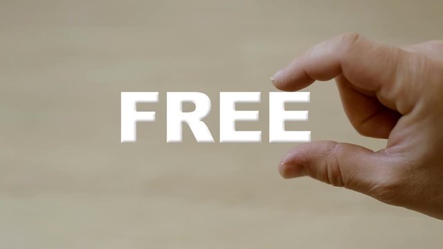 Hand holding the word free