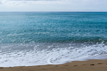 Fototapeta na wymiar Sea on a sandy beach in europe