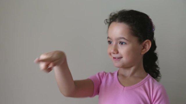 Adorable girl pointing and clicking the air