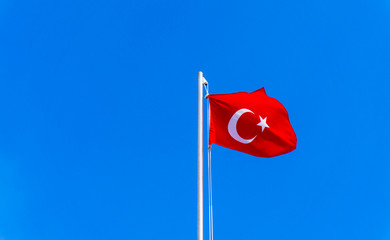 turkish flag waving in blue sky