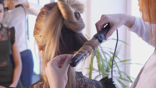 Hairdresser creating a hairstyle with flocks