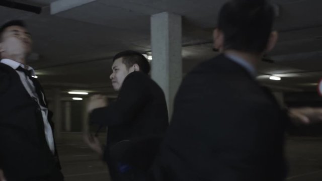  Asian gangster fighting in parking lot with members of a rival gang