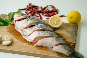 Preparing for Seabass steam with lemon, garlic and chili - Thai food, isolated on white background