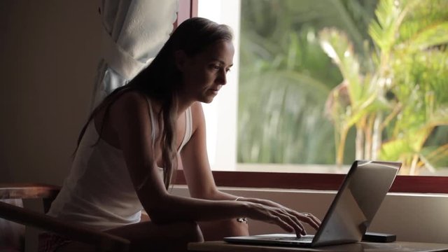 Young woman using laptop computer at home